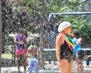 Linet Toledano, 7, of Roxbury cools off in the water spray at Mission Hill Playground at the City’s Splash Dance Party held on July 19, when the high temperature was a record-breaking 99 degrees. Sponsored by Mayor Thomas Menino and the Boston Parks and Recreation Department, the party also included ice cream distributed by the Boston Police Department. (Courtesy Photo)
