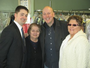 Sofia Marmanidis (second from left), owner of Sofia’s Alterations and Cleaners at 824 Huntington Ave., is congratulated on her shop being named Mission Hill Main Street’s Business of the Year by (from left) City Councilor Josh Zakim, MHMS Board President Dermot Doyne and MHMS Board Clerk Toni Kmost last month at her store. (Photo by Richard Rouse)