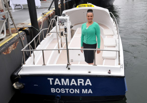 Mission Hill resident Tamara Allendorf stands inside a Boston Harbor Cruises boat named after her during the launch of a new water taxi service on the harbor on June 4. Allendorf, BHC’s revenue department manager, is one of eight employees honored with vessels named after them. For more info, call 617-227-4320 or use the Uber phone app through June 15, which now includes the “UberBOAT” water taxi option. (Courtesy Photo)